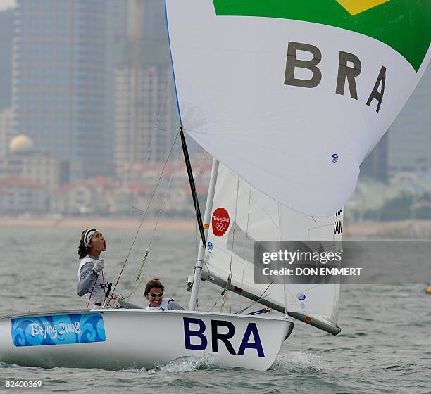 Sailors Fernanda Oliveira and Isabel Swan of Brazil celebrate while crossing the finish of the final race in the 470 women's class during the 2008...