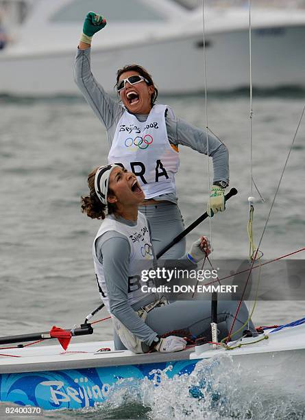 Sailors Fernanda Oliveira and Isabel Swan of Brazil celebrate while crossing the finish of the final race in the 470 women's class during the 2008...
