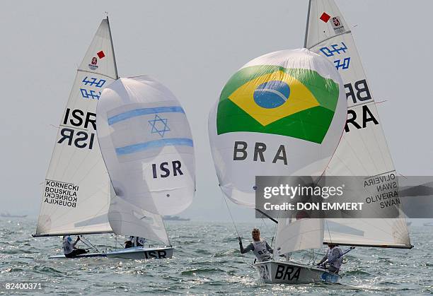 Sailors Fernanda Oliveira and Isabel Swan of Brazil lead in front of the Israely team while during the final race in the 470 women's class during the...