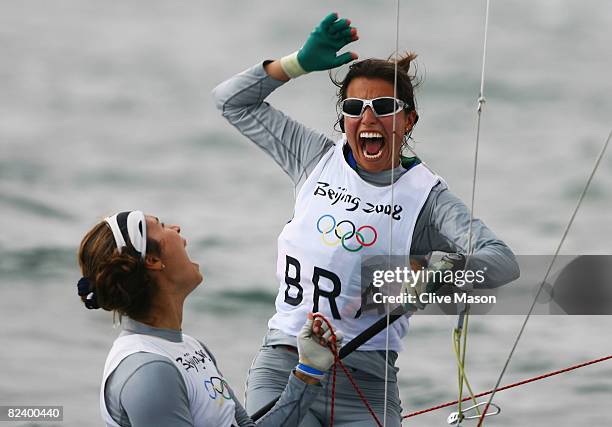 Fernanda Oliveira of Brazil celebrates with team mate Isabel Swan after they finished third overall in the Women's 470 class event held at the...