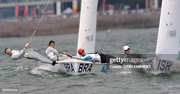 Sailors Nike Kornecki and Vered Bouskila of Israel , and Fernanda Oliveira and Isabel Swan of Brazil race during the 470 women's class event of the...
