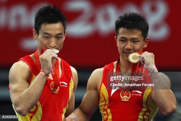 Silver medalist Yang Wei of China and gold medalist Chen Yibing of China pose after the medal ceremony for men's rings final of the artistic...