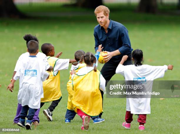 Prince Harry plays handball with children taking part in a StreetGames 'Fit and Fed' summer holiday activity session in Central Park, East Ham on...