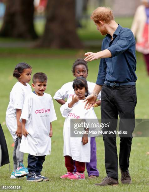 Prince Harry plays handball with children taking part in a StreetGames 'Fit and Fed' summer holiday activity session in Central Park, East Ham on...