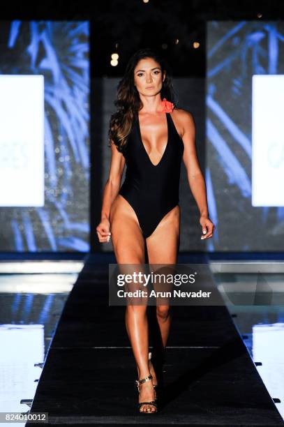 Model walks the runway during the Gabriela Pires fashion show for Art Hearts Fashion Miami Swim Week at SLS Hyde Beach on July 22, 2017 in Miami,...