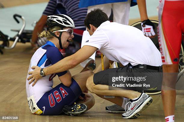 Sarah Hammer of the United States is tended to after crashing during women's points race event at the Laoshan Velodrome on Day 10 of the Beijing 2008...