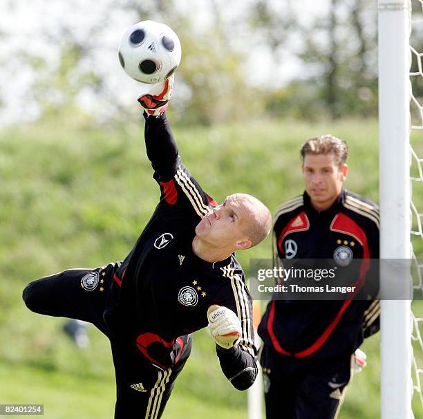 Robert Enke of Germany tries to catch a ball while Tim Wiese watches him during a training session of the German national football team at the Adi...