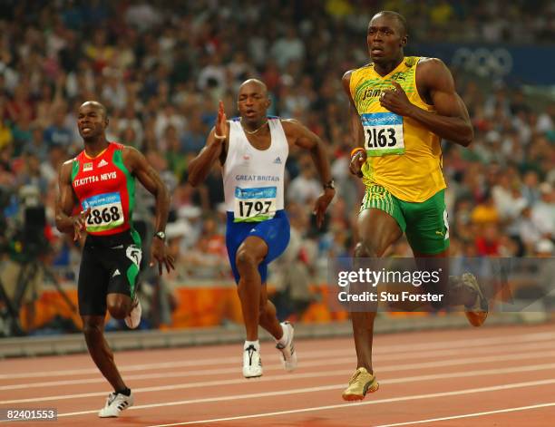 Kim Collins of Saint Kitts and Nevis, Marlon Devonish of Great Britain and Usain Bolt of Jamaica compete in the Men's 200m Semi Final at the National...