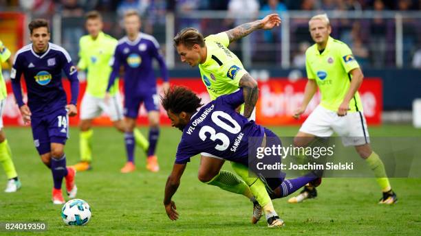 Nazim Sangare of Osnabrueck challenges Manuel Schaeffler of Wehen Wiesbaden during the 3. Liga match between VfL Osnabrueck and SV Wehen Wiesbaden at...