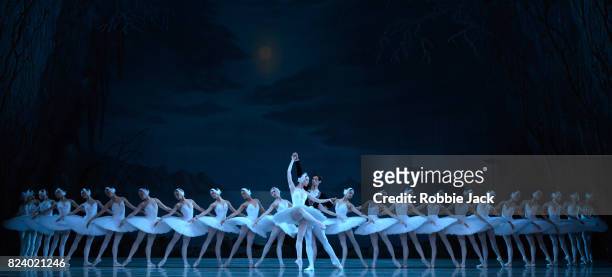 Viktoria Tereshkina as Odette and Xander Parish as Prince Siegfried with artists of the company in The Mariinsky Ballet's production of Konstantin...