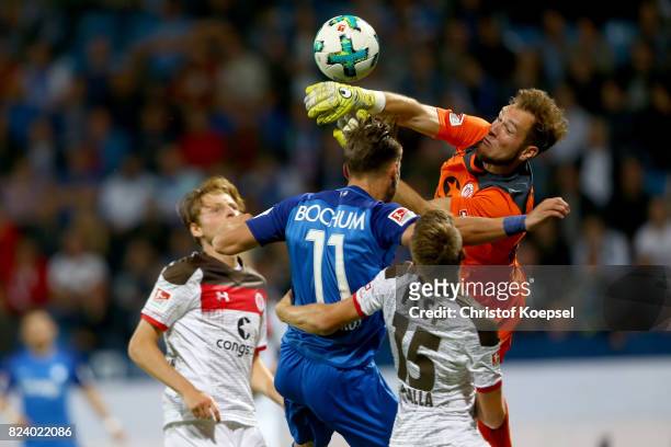 Robin Himmelmann of St. Pauli saves the ball against Dimitrios Diamantakos of Bochum during the Second Bundesliga match between VfL Bochum 1848 and...