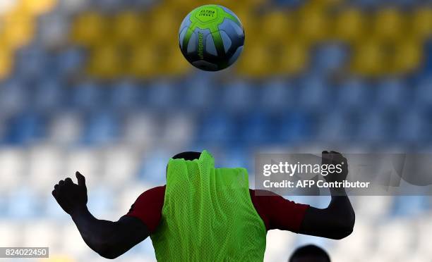 Monaco's French defender Djibril Sidibe heads the ball during a training session at the Grand Stade in Tangiers on July 28, 2017 on the eve of the...