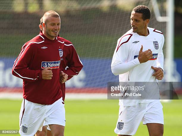 England internationals David Beckham and Rio Ferdinand jog around the pitch as they warm up during the England Training and Press Conference at...