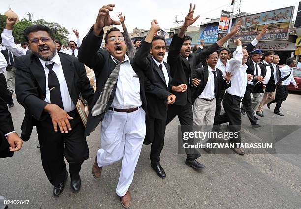 Pakistani lawyers celebrate the resignation of President Pervez Musharraf during a march on a street in Karachi on August 18, 2008. Musharraf...