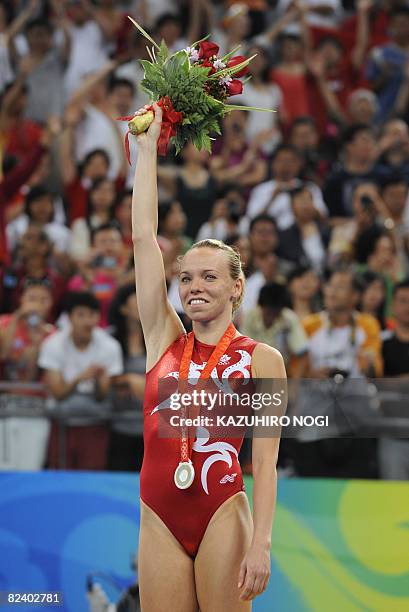 Canada's Karen Cockburn stands on the podium after the women's trampoline final of the artistic gymnastics event of the Beijing 2008 Olympic Games in...
