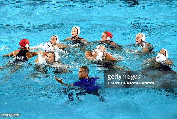 Head coach Adam Krikorian of the United States celebrates with his players following their team's 13-6 victory during the Women's Water Polo gold...