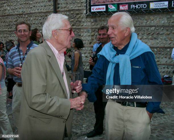 Photo editor John G. Morris shakes hands with US photojournalist David Douglas Duncan during a reception in "Visa Pour l'Image" International...