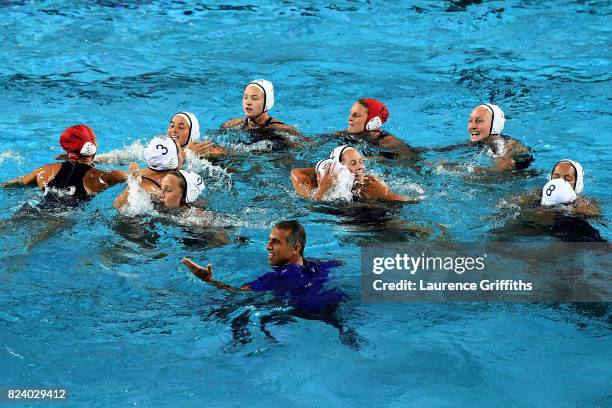 Head coach Adam Krikorian of the United States celebrates with his players following their team's 13-6 victory during the Women's Water Polo gold...