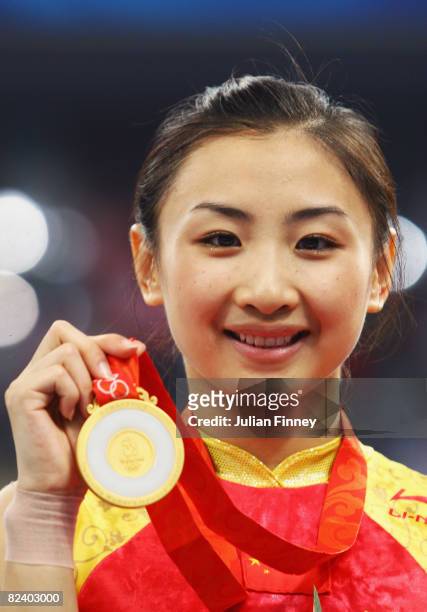 He Wenna of China stands on the podium during the medal ceremony after winning gold in the trampoline women?s final gymnastics event at the National...