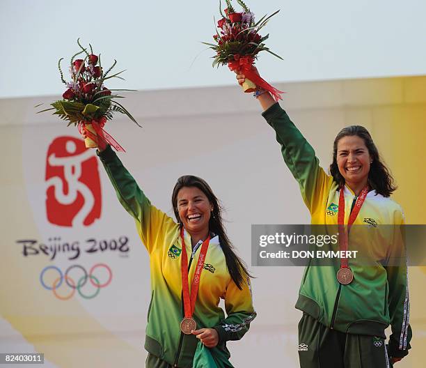 Sailors Fernanda Oliveira and Isabel Swan of Brazil of the 470 women's class celebrate their bronze medal on the podium at the 2008 Beijing Olympic...