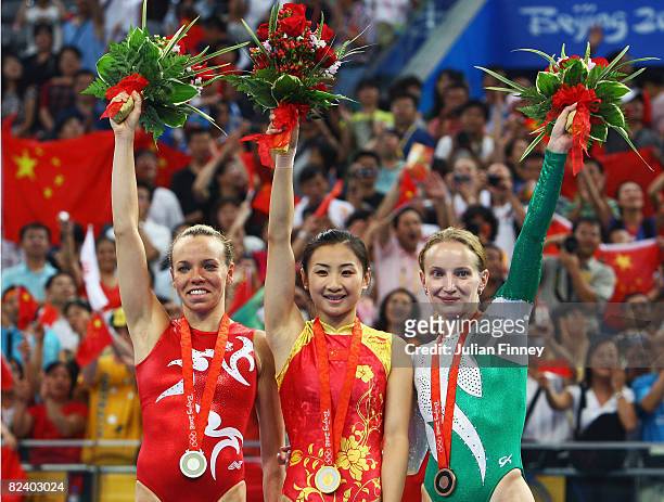 Silver medalist Karen Cockburn of Canada, gold medalist He Wenna of China and bronze medalist Ekaterina Khilko of of Uzbekistan stand on the podium...