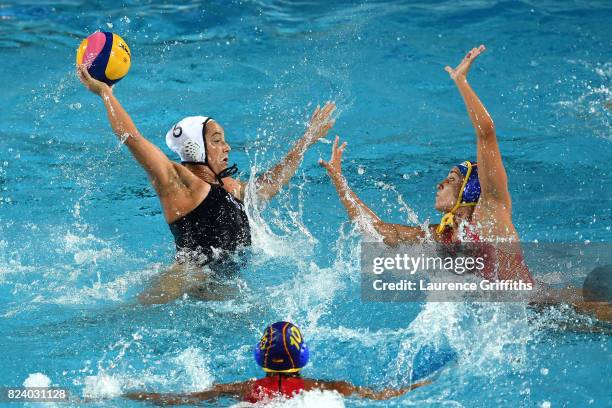 Margaret Steffens of United States shoots under pressure from Helena Lloret Gomez of Spain during the Women's Water Polo gold medal match between the...