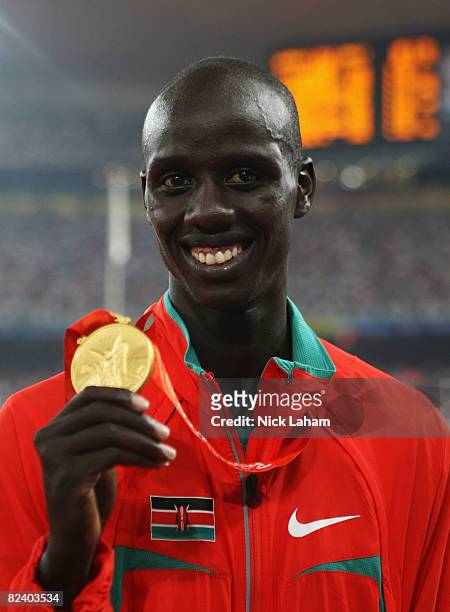 Brimin Kipruto of Kenya receives the gold medal during the medal ceremony for the Men's 3000m Steeplechase Final at the National Stadium on Day 10 of...