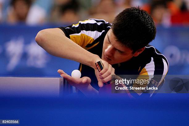 Dimitrij Ovtcharov of Germany plays a shot during the Men's Team Contest against China at the Peking University Gymnasium on Day 10 of the Beijing...