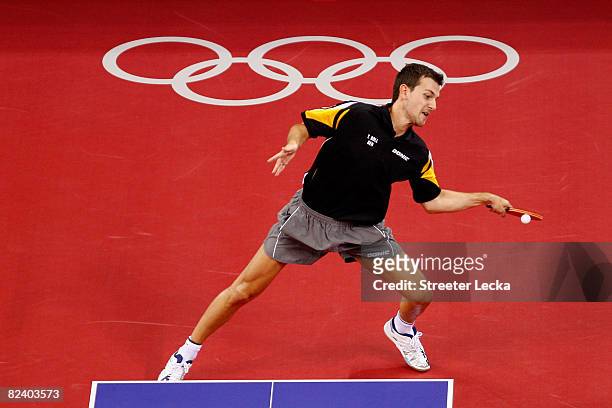Timo Boll of Germany plays a shot during the Men's Team Contest against China at the Peking University Gymnasium on Day 10 of the Beijing 2008...