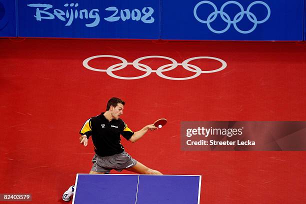 Timo Boll of Germany plays a shot during the Men's Team Contest against China at the Peking University Gymnasium on Day 10 of the Beijing 2008...