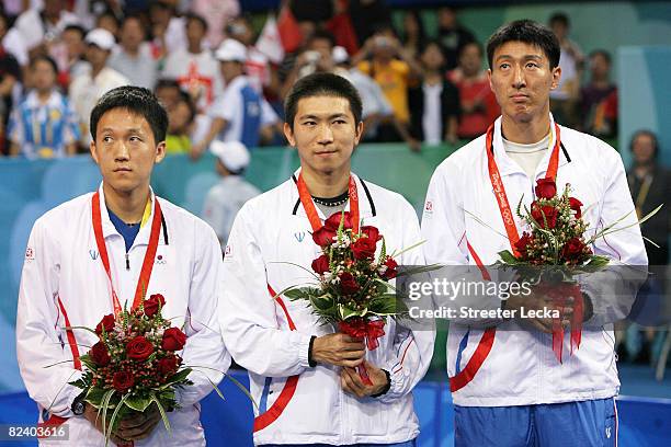 Sang Eun Oh, Seung Min Ryu and Jae Young Yoon of Korea celebrate their silver medal in the Men's Team Contest against China at the Peking University...