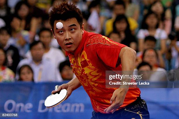 Hao Wang of China hits a shot during the Men's Team Contest against Germany at the Peking University Gymnasium on Day 10 of the Beijing 2008 Olympic...