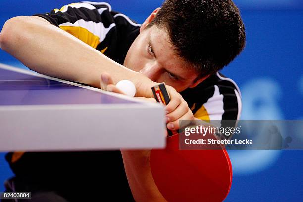 Dimitrij Ovtcharov of Germany plays a shot during the Men's Team Contest against China at the Peking University Gymnasium on Day 10 of the Beijing...