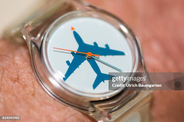 Symbol photo on the topics aviation, flying, punctuality, strike, etc. The photo shows a Swatch wrist watch with an airplane symbol.