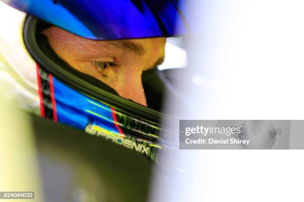 Ben Kennedy, driver of the Menards Toyota, sits in his car during practice for the NASCAR K&N Pro Series East Casey's General Store 150 at Iowa...
