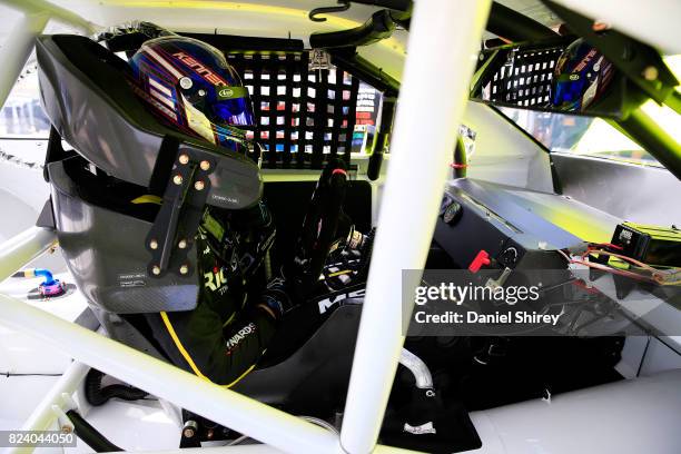 Ben Kennedy, driver of the Menards Toyota, sits in his car during practice for the NASCAR K&N Pro Series East Casey's General Store 150 at Iowa...