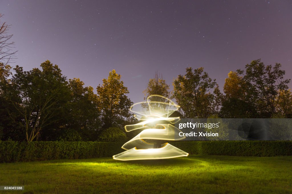 Light painting in the grass field in nature background