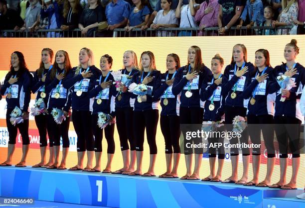 Players sing their national anthem on the podium after winning the women's final water polo match between USA and Spain during the FINA2017 world...