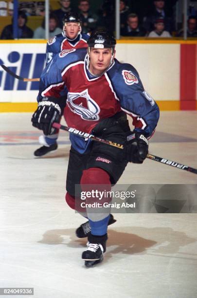 Mike Ricci of the Colorado Avalanche skates up ice against the Toronto Maple Leafs during game action on December 11, 1995 at Maple Leaf Gardens in...