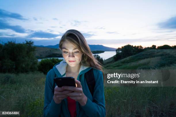 teenage girl using her smart phone while hiking - girl who stands stock pictures, royalty-free photos & images