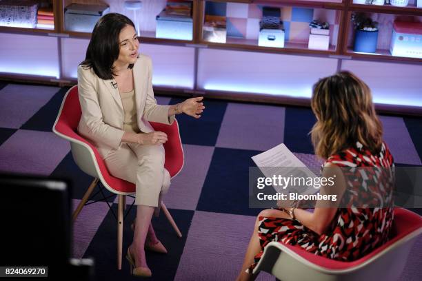 Sheryl Sandberg, chief operating officer of Facebook Inc., left, speaks during a Bloomberg Studio 1.0 television interview at Facebook headquarters...