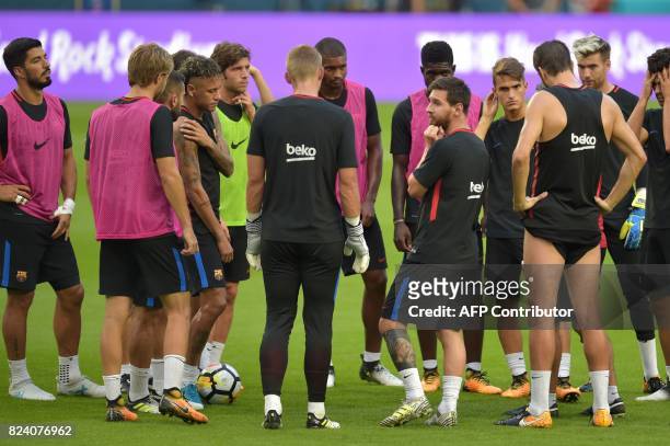 Barcelona players Lionel Messi and Neymar take part in a training session at Hard Rock Stadium in Miami, Florida, on July 28 one day before their...