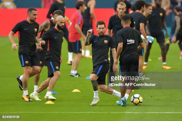 Barcelona player Lionel Messi and teammates take part in a training session at Hard Rock Stadium in Miami, Florida, on July 28 one day before their...
