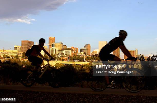 Cyclists pedal along the South Platte River across from the downtown city skyline on August 12, 2008 in Denver, Colorado. The city is preparing to...