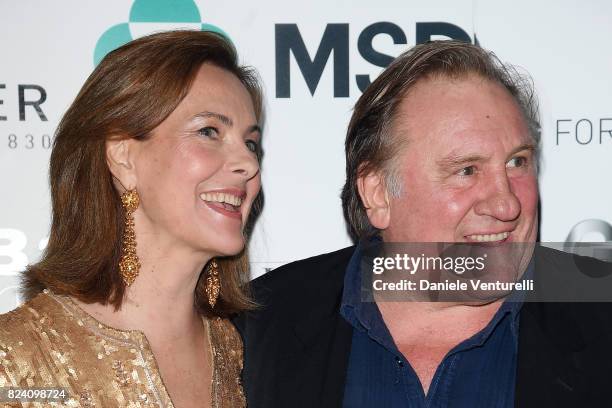 Carole Bouquet and Gerard Depardieu attend Nations Award gala dinner on July 28, 2017 in Taormina, Italy.