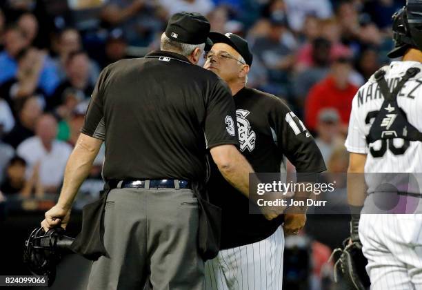 Manager Rick Renteria of the Chicago White Sox talks with home plate umpire Tim Welke between pitches during the fourth inning at Guaranteed Rate...