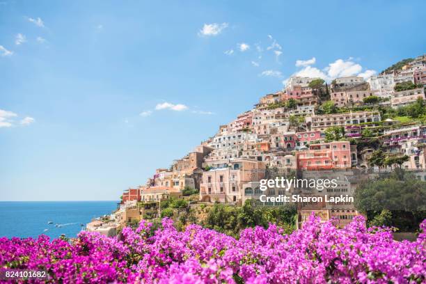 positano framed by pink bougainvillea - positano italy stock pictures, royalty-free photos & images