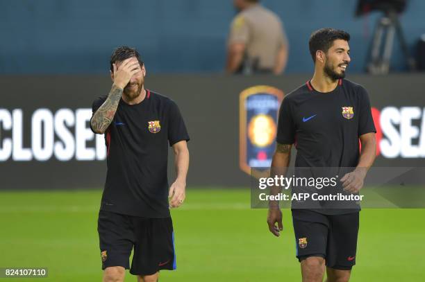 Barcelona players Lionel Messi and Luis Suarez take part in a training session at Hard Rock Stadium in Miami, Florida, on July 28 one day before...