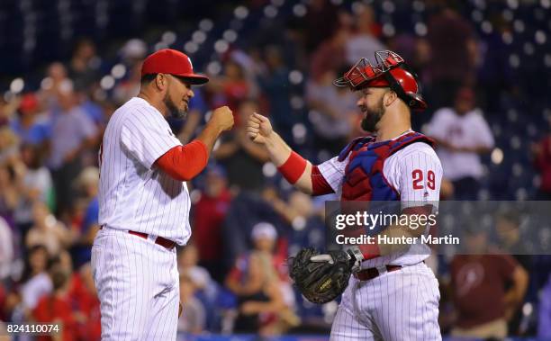 Joaquin Benoit of the Philadelphia Phillies is congratulated by Cameron Rupp after finishing a game against the Atlanta Braves at Citizens Bank Park...