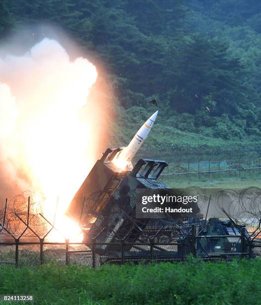 In this handout photo released by the South Korean Defense Ministry, U.S. Army Tactical Missile System firing a missile into the East Sea during a...
